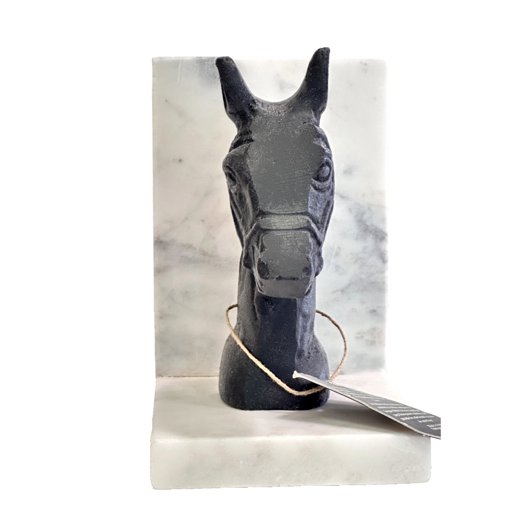 Black horse head sculpture on a marble base