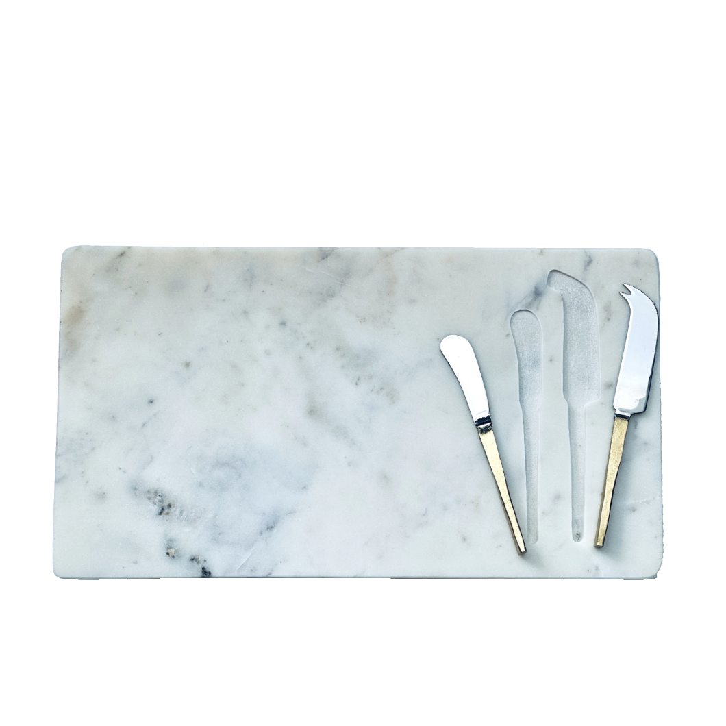 Marble cutting board with three knives on a white background