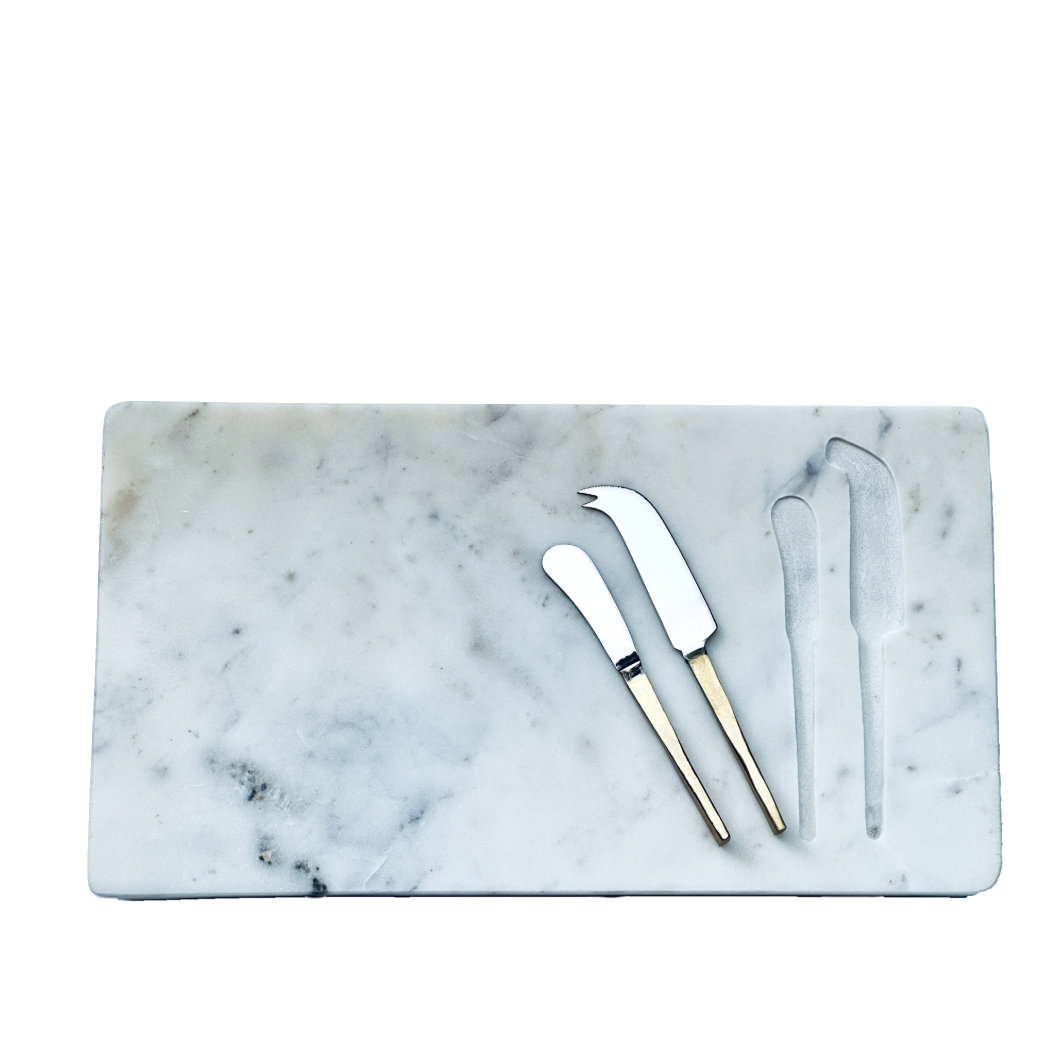 Marble cutting board with three cheese knives on a white background