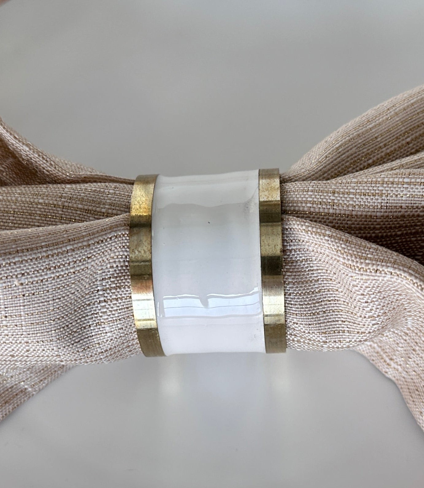 white napkin ring with gold rim