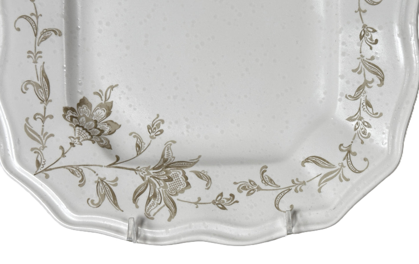 Decorative white plate with floral patterns on a white background