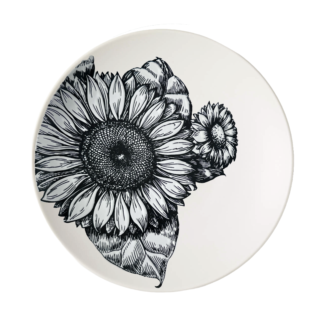 Round cream colored ceramic dinner plate with black and white sunflower design