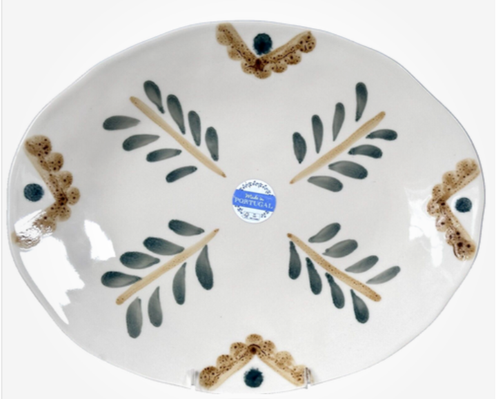 Ceramic plate with leaf design and 'Made in Portugal' label on a white background