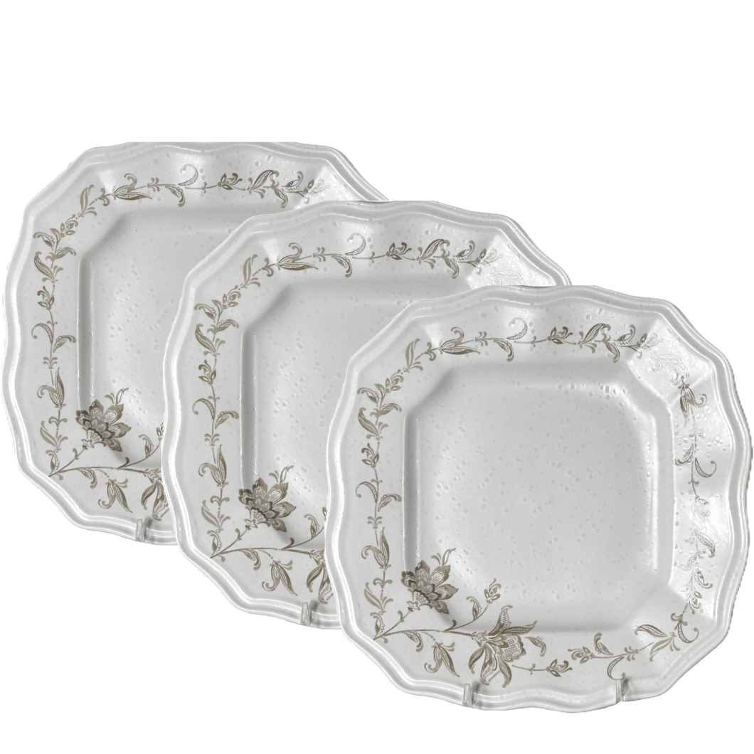 Set of three decorative plates with floral patterns on a white background