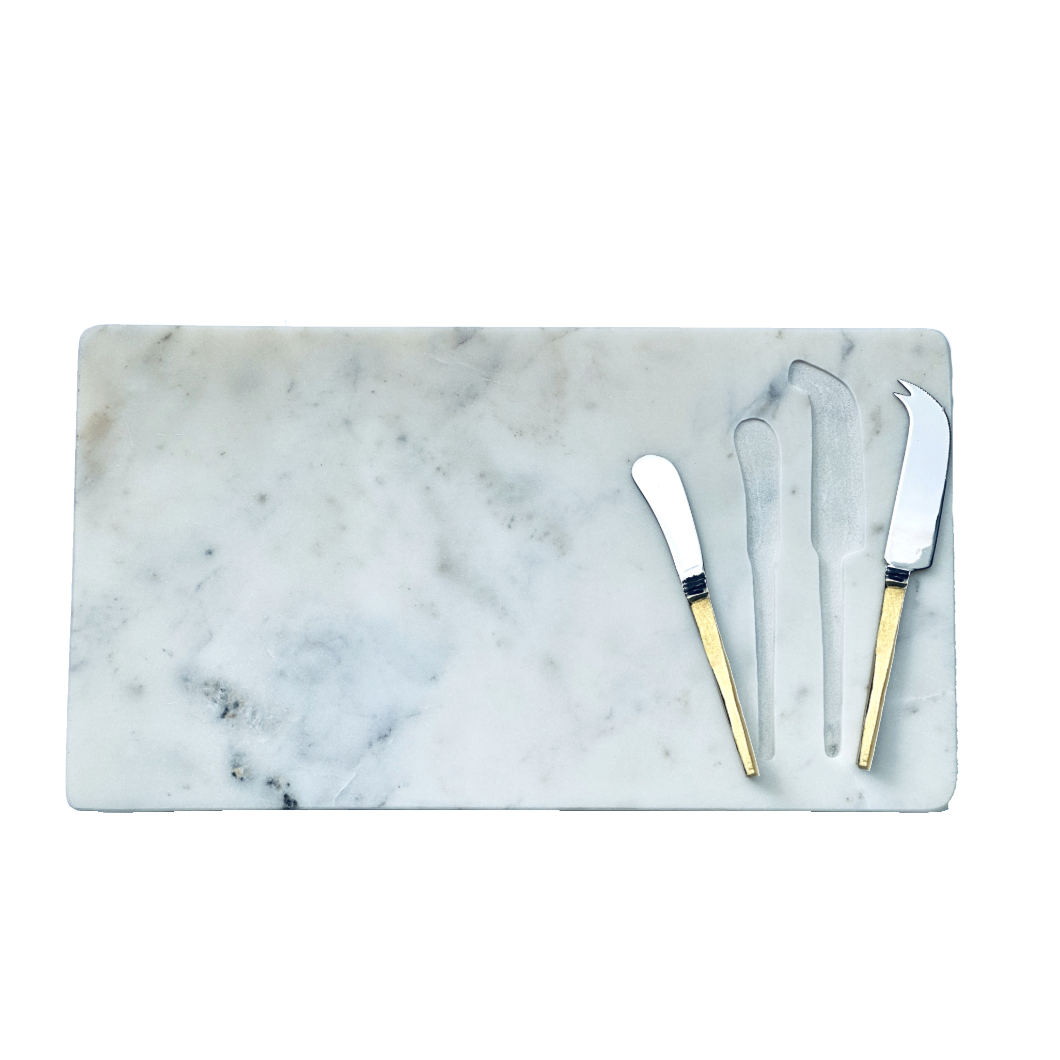 Marble cutting board with gold-handled knives on a white background