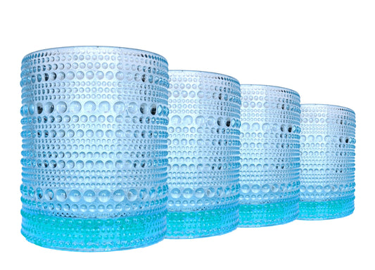 Set of four blue hobnail stemless wine glasses on a white background