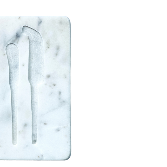 Marble cutting board with knife and fork on a white background