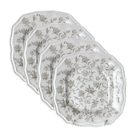 Set of four 8.25" square decorative plates with floral patterns and a scalloped rim on a white background