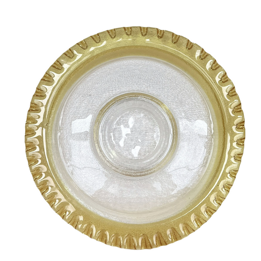 Clear glass dish with gold decorative rim on a white background