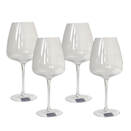 Set of four clear wine glasses on a white background