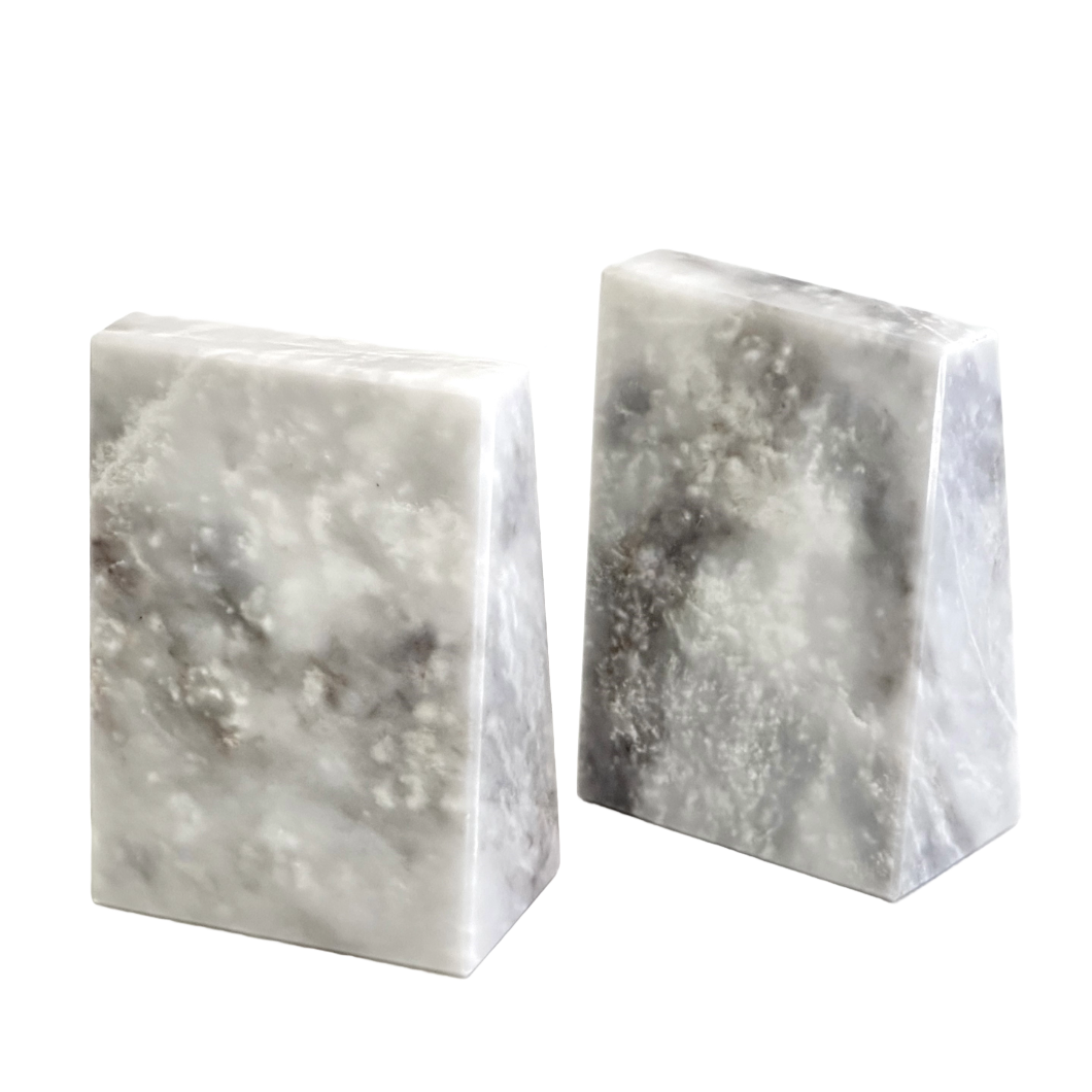 Two marble bookends on a white background