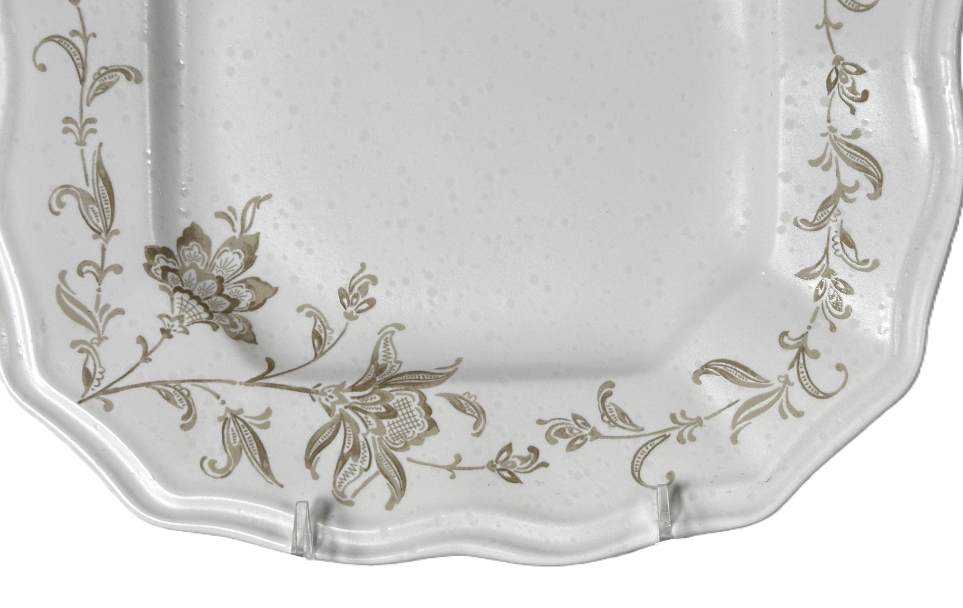 Decorative white plate with floral patterns on a white background