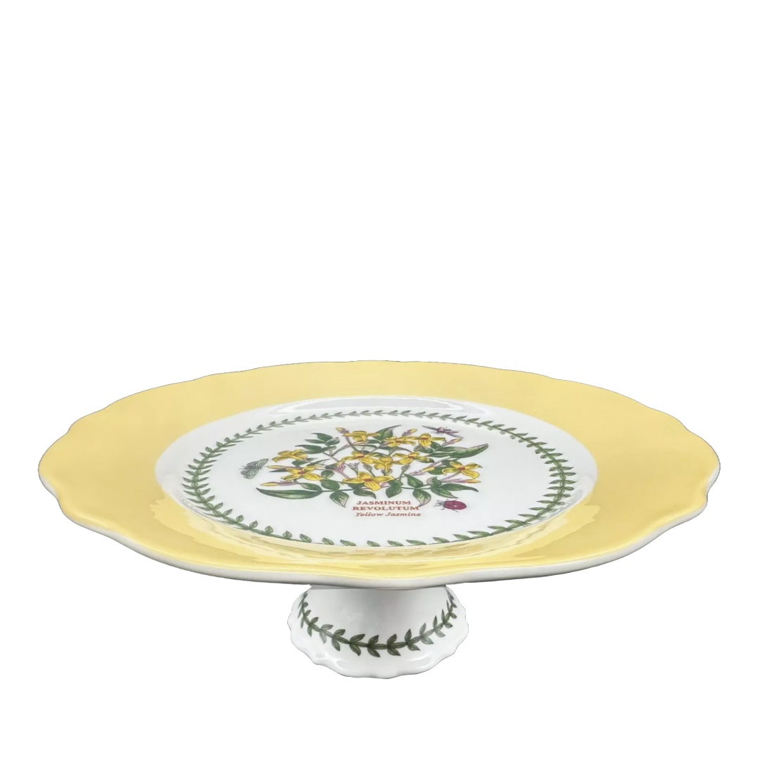 Yellow ceramic cake holder with green leaf pattern 