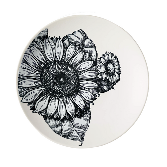 Round cream colored ceramic dinner plate with black and white sunflower design