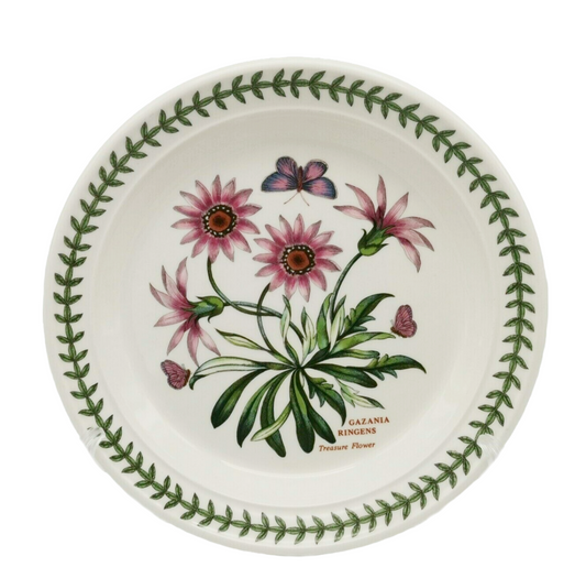 Ceramic plate with floral design and green leaf border on a white background