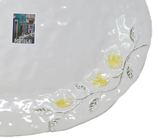 Round white pillow with floral patterns on a white background