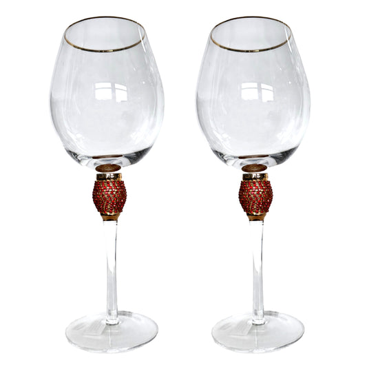 Two wine glasses with decorative stems on a white background