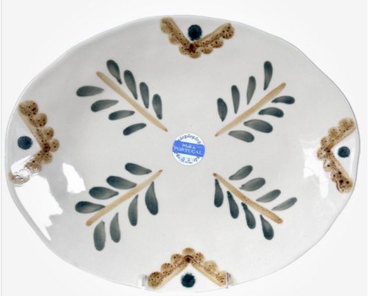 Ceramic plate with leaf design and 'Made in Portugal' label on a white background