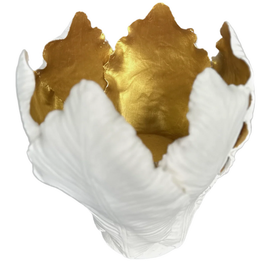 Decorative bowl with gold interior and white exterior on a white background