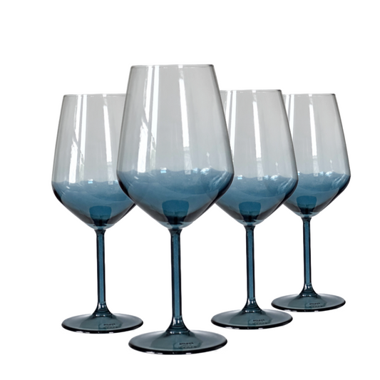 Set of four blue wine glasses on a white background