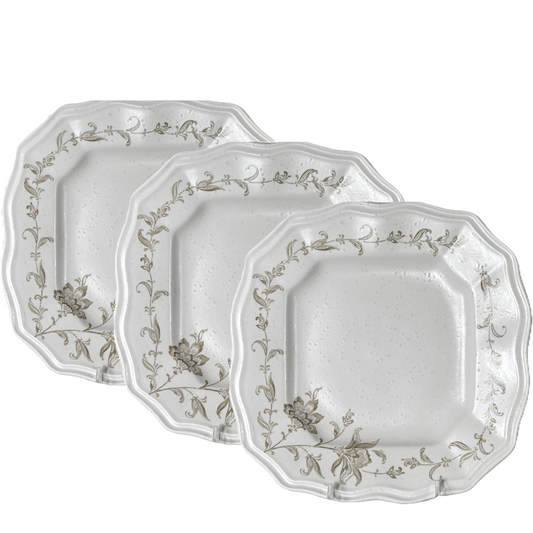 Set of three decorative plates with floral patterns on a white background